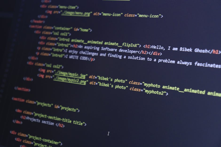 A detailed close-up photograph of a computer screen displaying colorful HTML and CSS code, with various tags and attributes visible such as '<h1>', '<div>', and '<img>'. The code includes lines refere